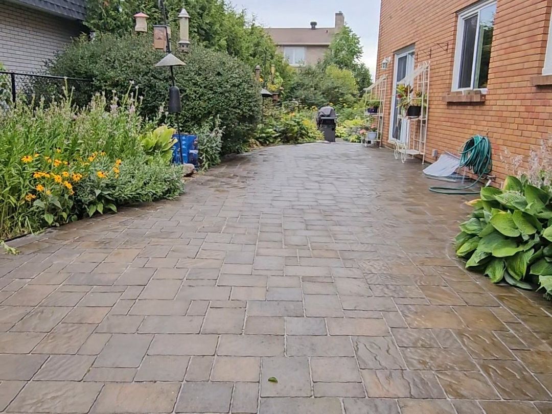 The same interlock patio pressure washed, showing clean tan and grey pavers with freshly filled joints