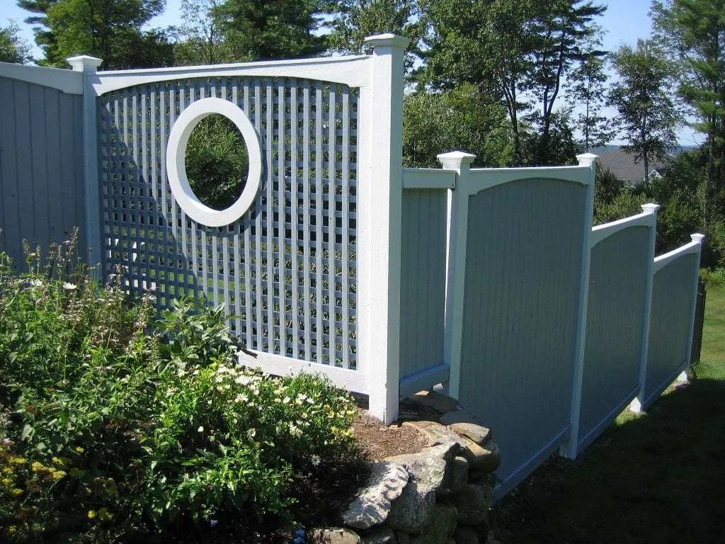 The same privacy screens repainted blue-grey with crisp white trim around the round window