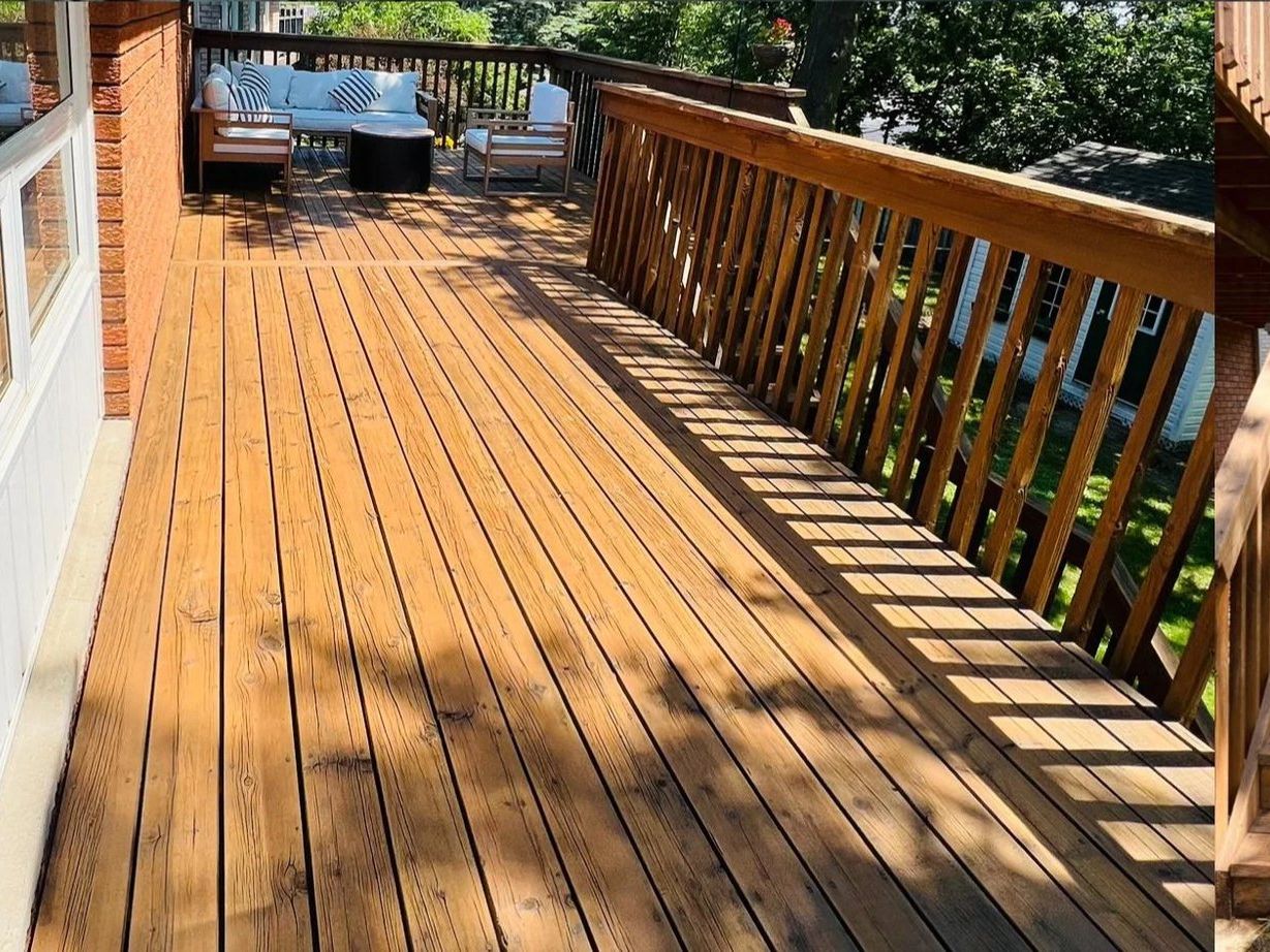 The same deck, railings and stairs coated in a warm cedar-tone waterproof finish