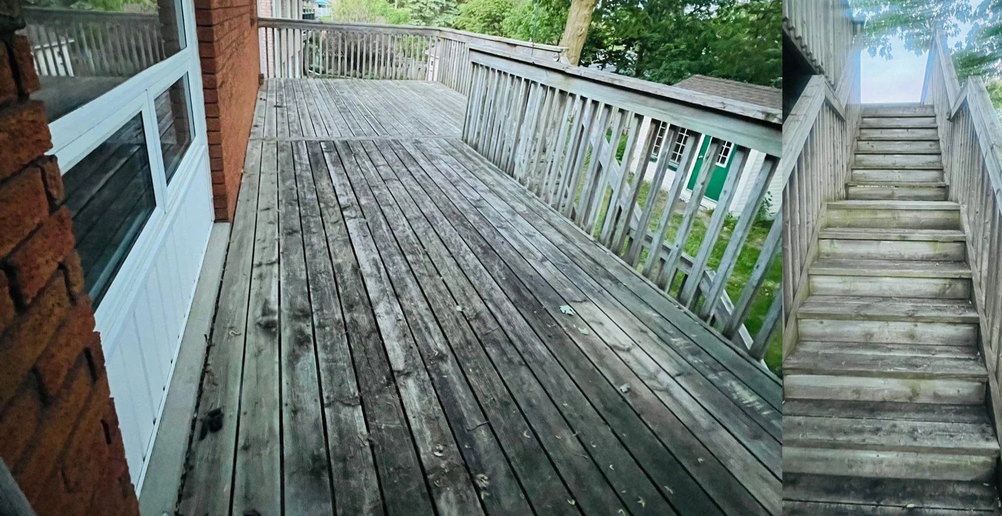 Grey, weathered wooden deck and stairs beside a brick wall